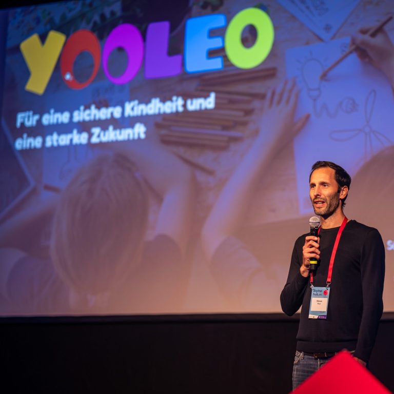 Gianna und Simon sind das Gründer-Team von YOOLEO. Sie sitzen nebeneinander und lächeln